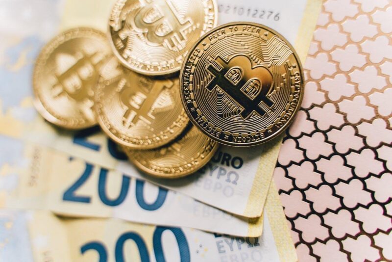 Bitcoin coins and Euro bills